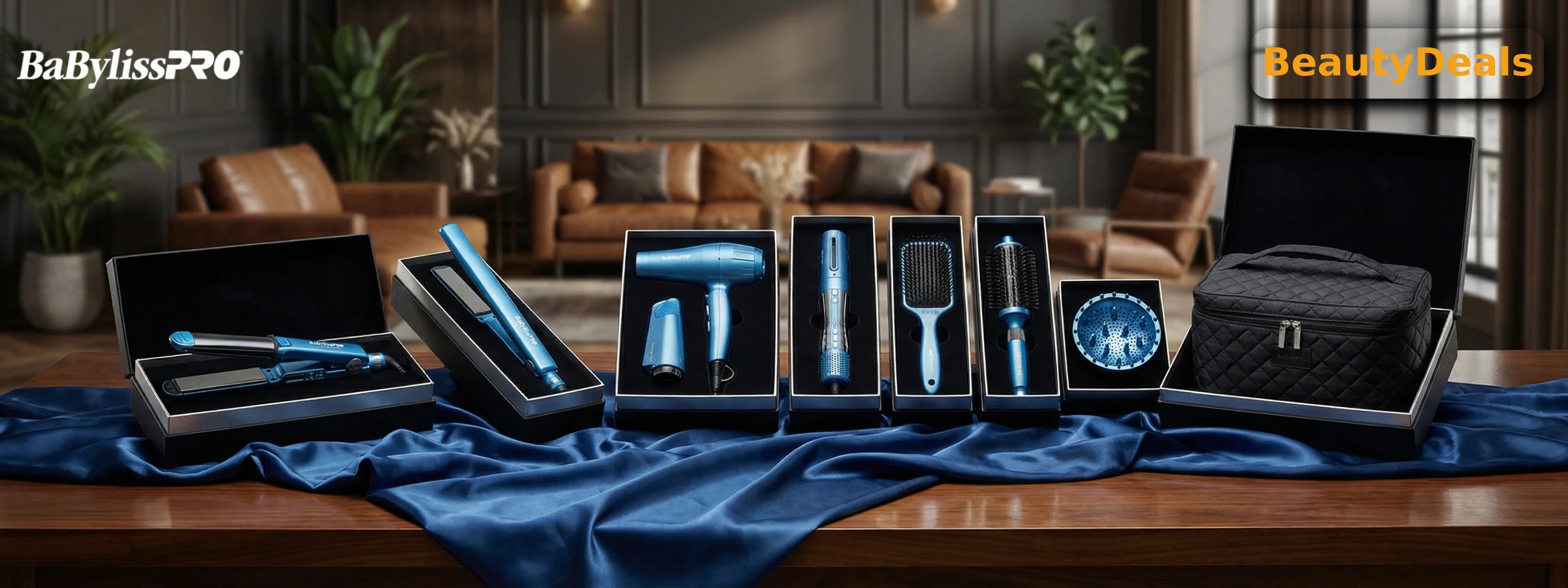 A panoramic display of BaBylissPRO hair styling tools in a shimmering metallic blue finish. The set includes a flat iron, blow dryer, curling wand, and styling brushes, each presented in luxury black gift boxes on a wooden table draped with blue silk.